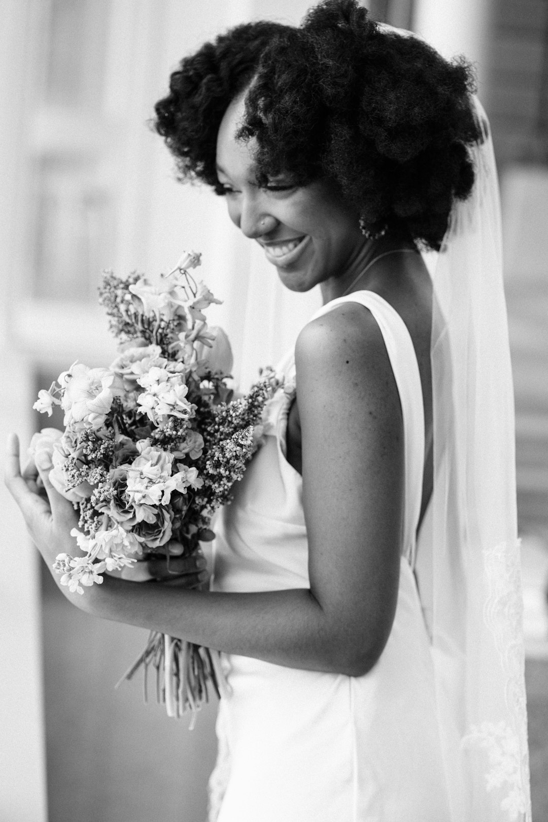 A woman in a wedding dress holding a bouquet of flowers